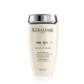Bottle of Bain Densifique shampoo, cream in colour with white bg